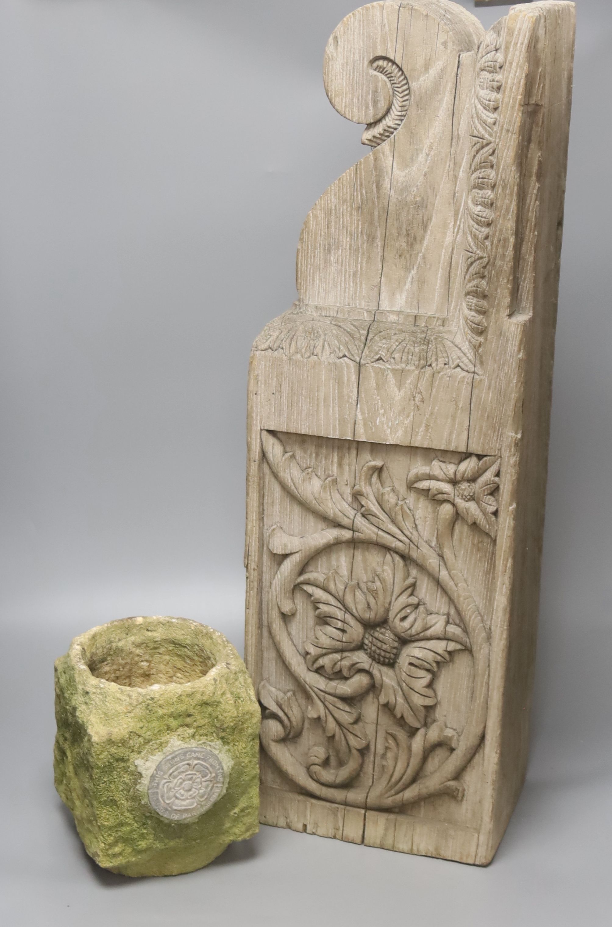 A sculpted stone pot labelled This Stone came from The Houses of Parliament, 15 x 15cm 19cm high, a teak architectural support, 18th century